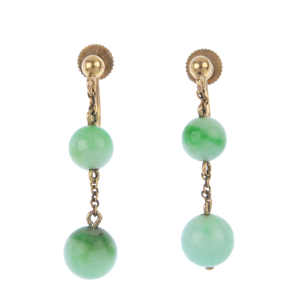 A pair of jade ear pendants. Each designed as two graduated jadeite beads, suspended along a trace-