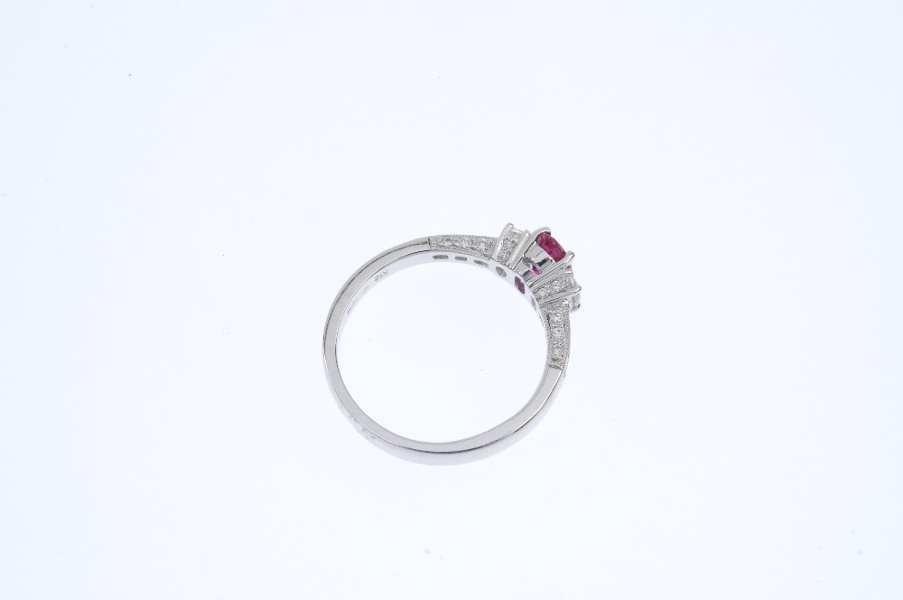 * An 18ct gold ruby and diamond dress ring. The oval-shape ruby and diamond sides, to the baguette- - Image 4 of 4