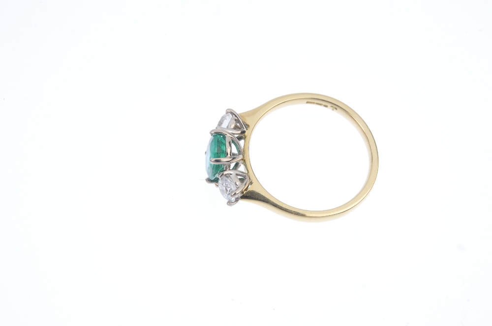 * An 18ct gold emerald and diamond three-stone ring. The oval-shape emerald, to the brilliant-cut - Image 3 of 4