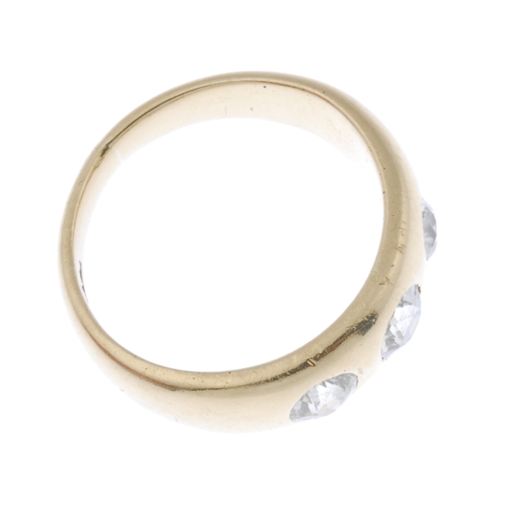 A late 19th century 18ct gold diamond three-stone ring. The slightly graduated old-cut diamond line, - Image 3 of 4