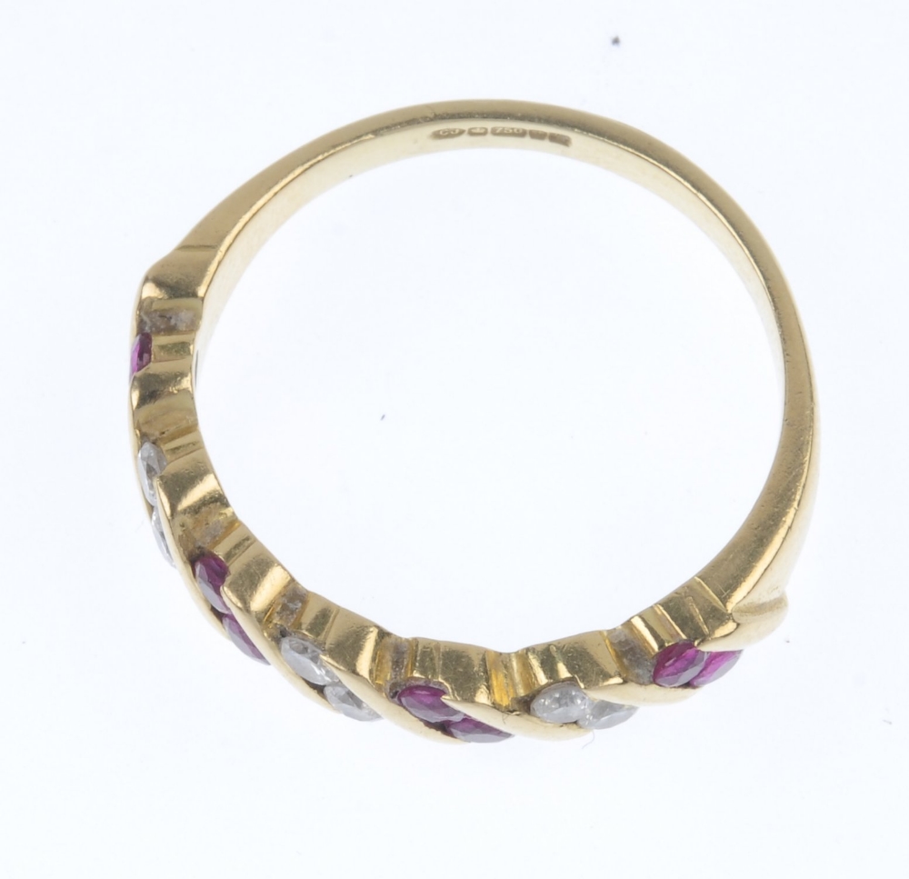 An 18ct gold ruby and diamond ring. Designed as a series of slanted circular-shape ruby pairs, - Image 2 of 4