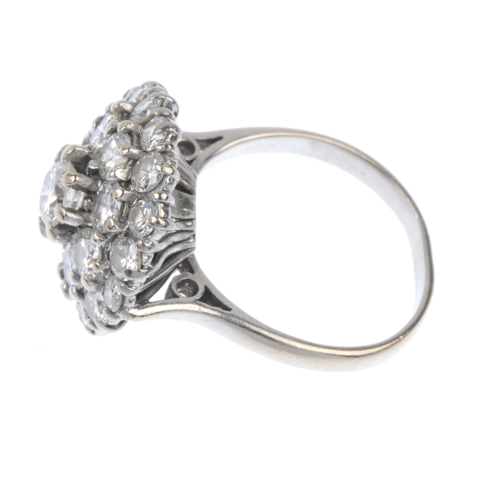 A diamond cluster ring. The brilliant-cut diamond stepped cluster, to the tapered sides and plain - Image 3 of 4