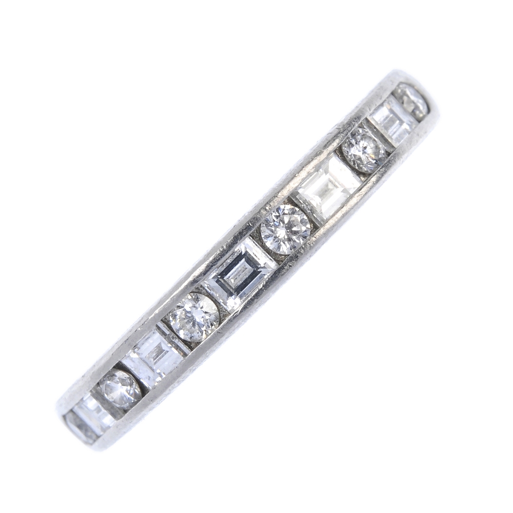 TIFFANY & CO. - a diamond half-circle eternity ring. The alternating brilliant and baguette-cut