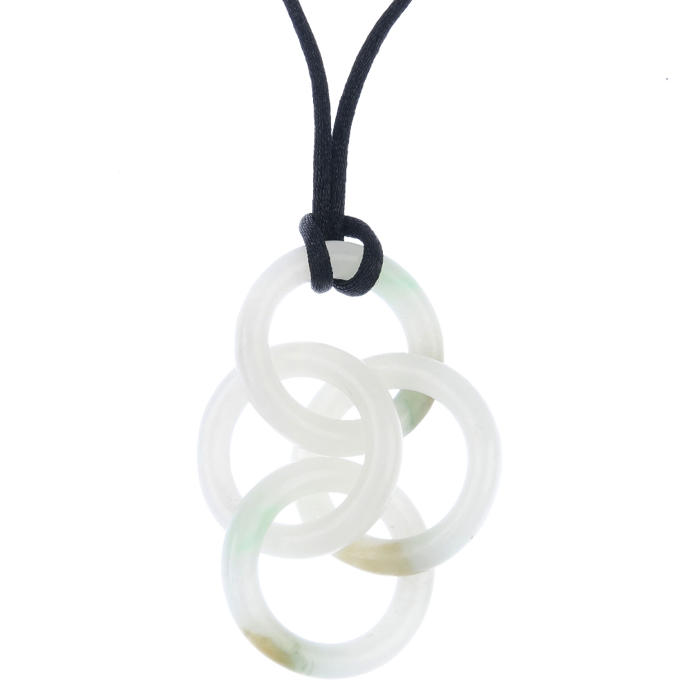 A jade pendant. Designed as a series of four interlocking nephrite jade hoops, to the black fabric