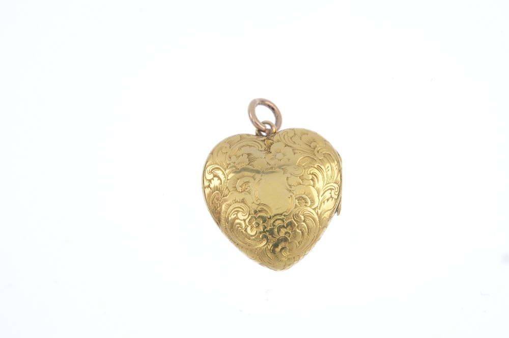 An early 20th century gold heart locket. The scroll engraved front panel, opening to reveal a - Image 2 of 3