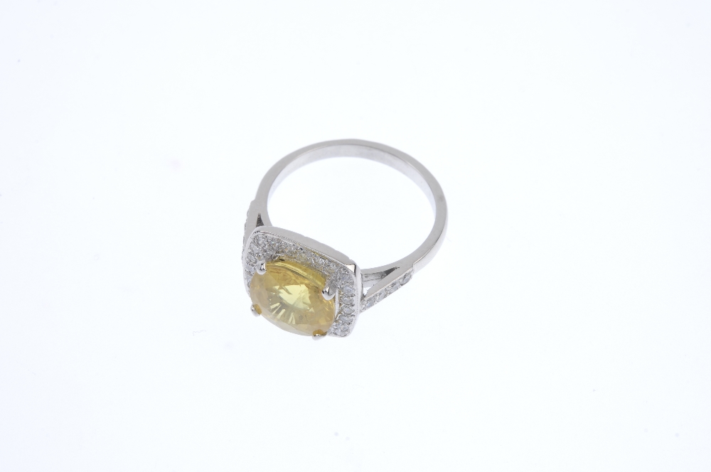 A sapphire and diamond dress ring. The cushion-shape yellow sapphire, with brilliant-cut diamond - Image 2 of 4