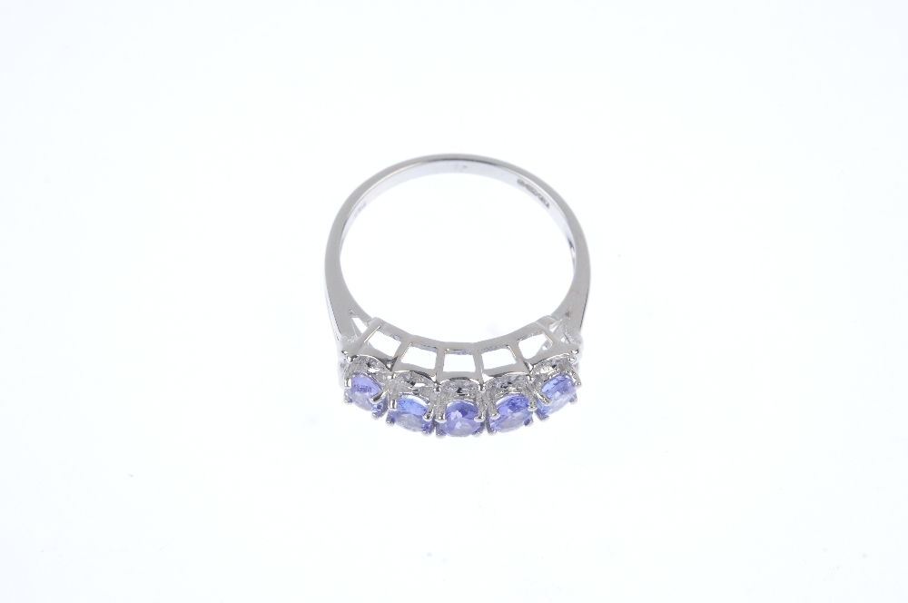 An 18ct gold tanzanite and diamond ring. The oval-shape tanzanite line, to the single-cut diamond - Image 2 of 4