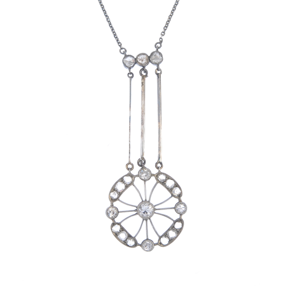 An early 20th century diamond pendant. The old and rose-cut diamond openwork panel, suspended from