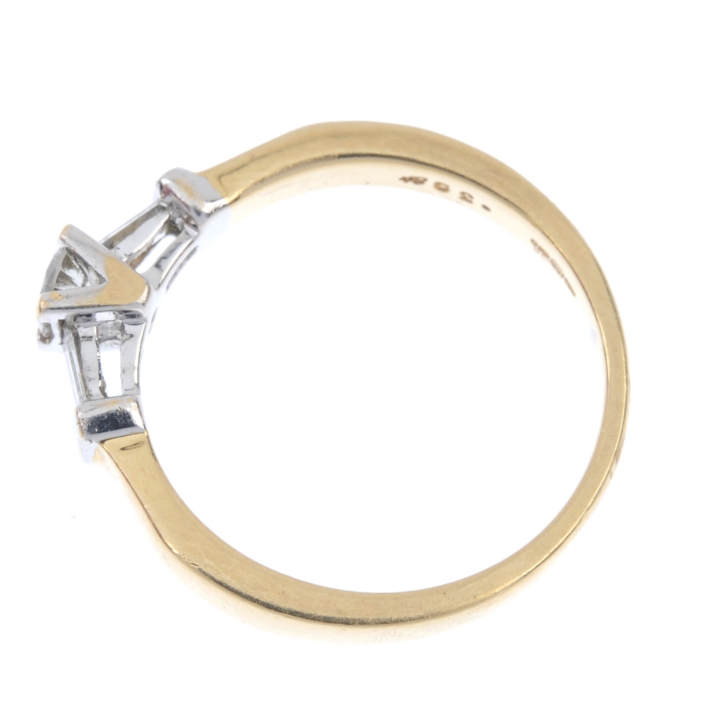 An 18ct gold diamond ring. Of bi-colour design, the brilliant-cut diamond, with baguette-cut diamond - Image 3 of 4