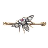A diamond and ruby insect brooch. The old and rose-cut diamond body and wings, with ruby cabochon