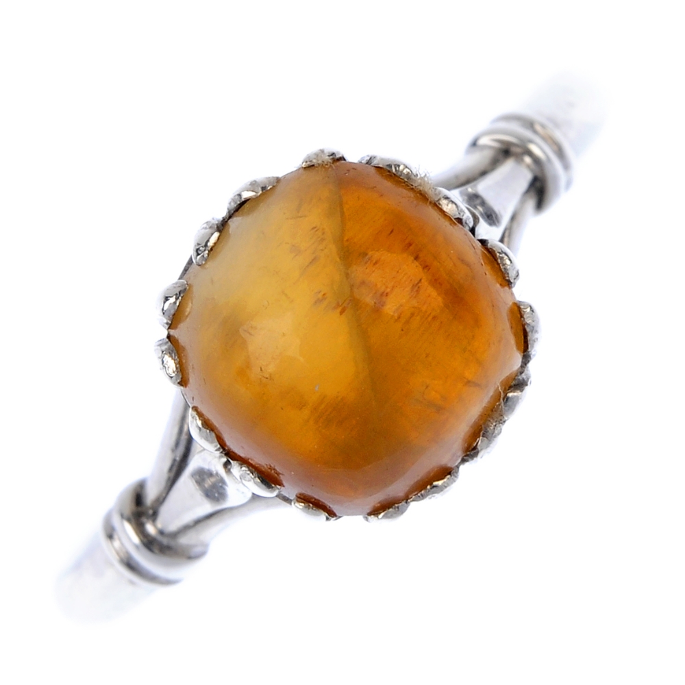 A cat's eye chrysoberyl single-stone ring. The cushion-shape chrysoberyl cabochon, within an