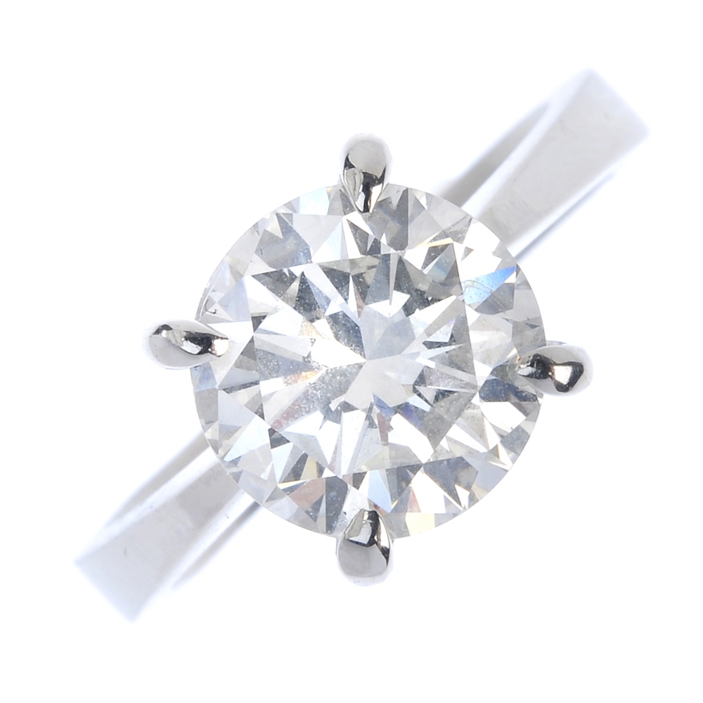 An 18ct gold diamond single-stone ring. The brilliant-cut diamond, weighing 3.02cts, to the plain
