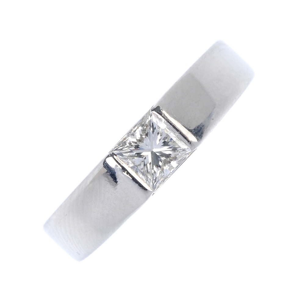 A platinum diamond single-stone ring. The square-shape diamond, to the slightly tapered band.