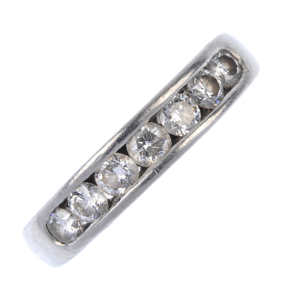 A platinum diamond band ring. The brilliant-cut diamond line, within a channel setting, to the