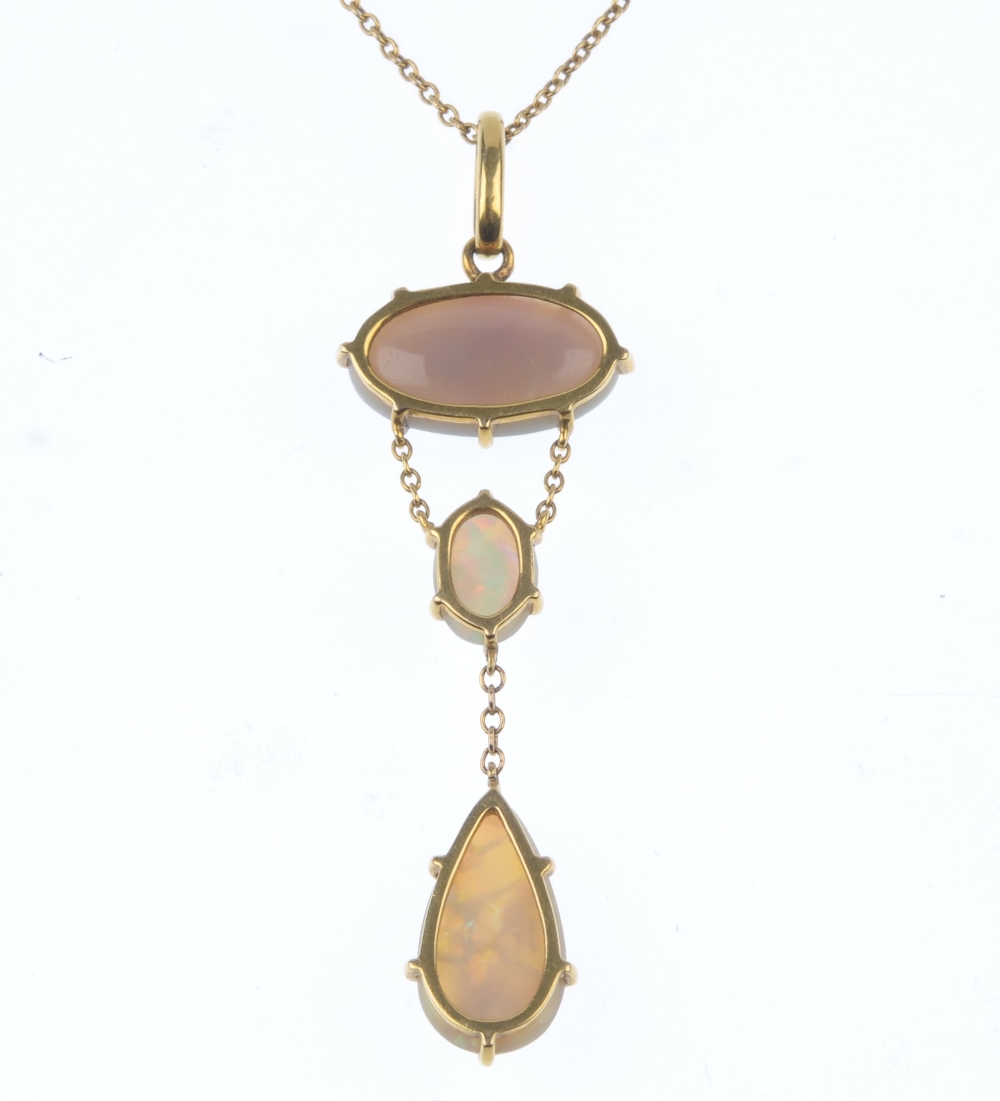 An opal pendant. The pear-shape opal cabochon, suspended from a belcher-link chain, to the oval opal - Image 2 of 3
