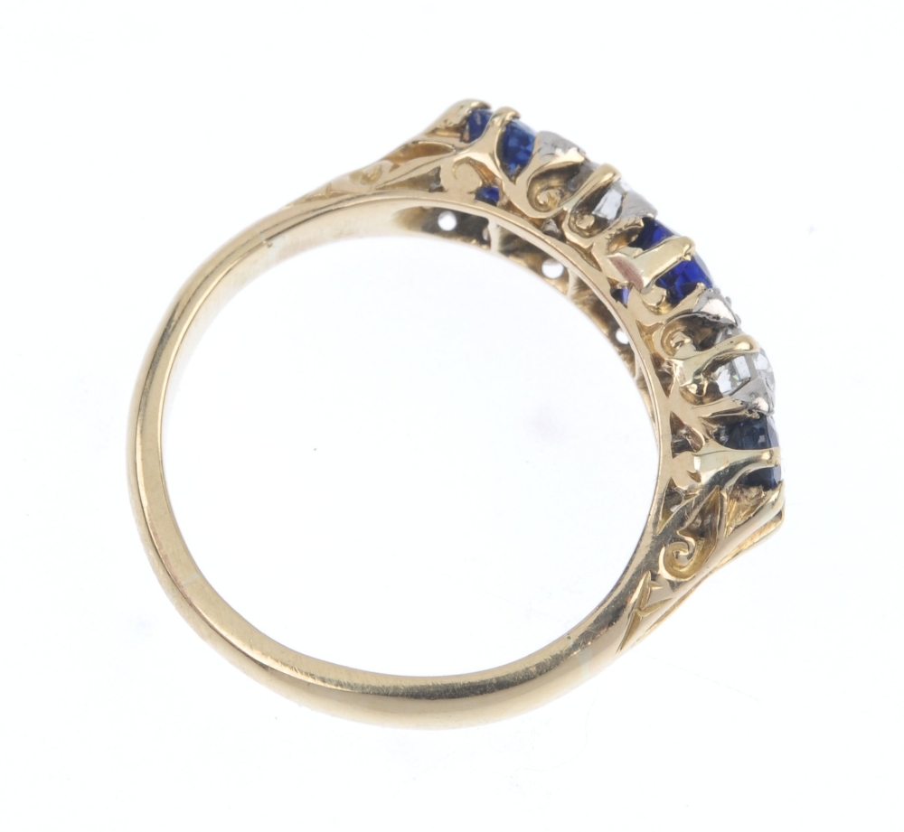 A sapphire and diamond ring. The graduated oval-shape sapphire line, with old-cut diamond spacers, - Image 4 of 4