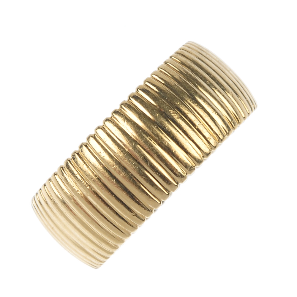 ANDREW GEOGHEGAN - an 18ct gold ring. Designed as a series of ridges, to the wide band. Maker's