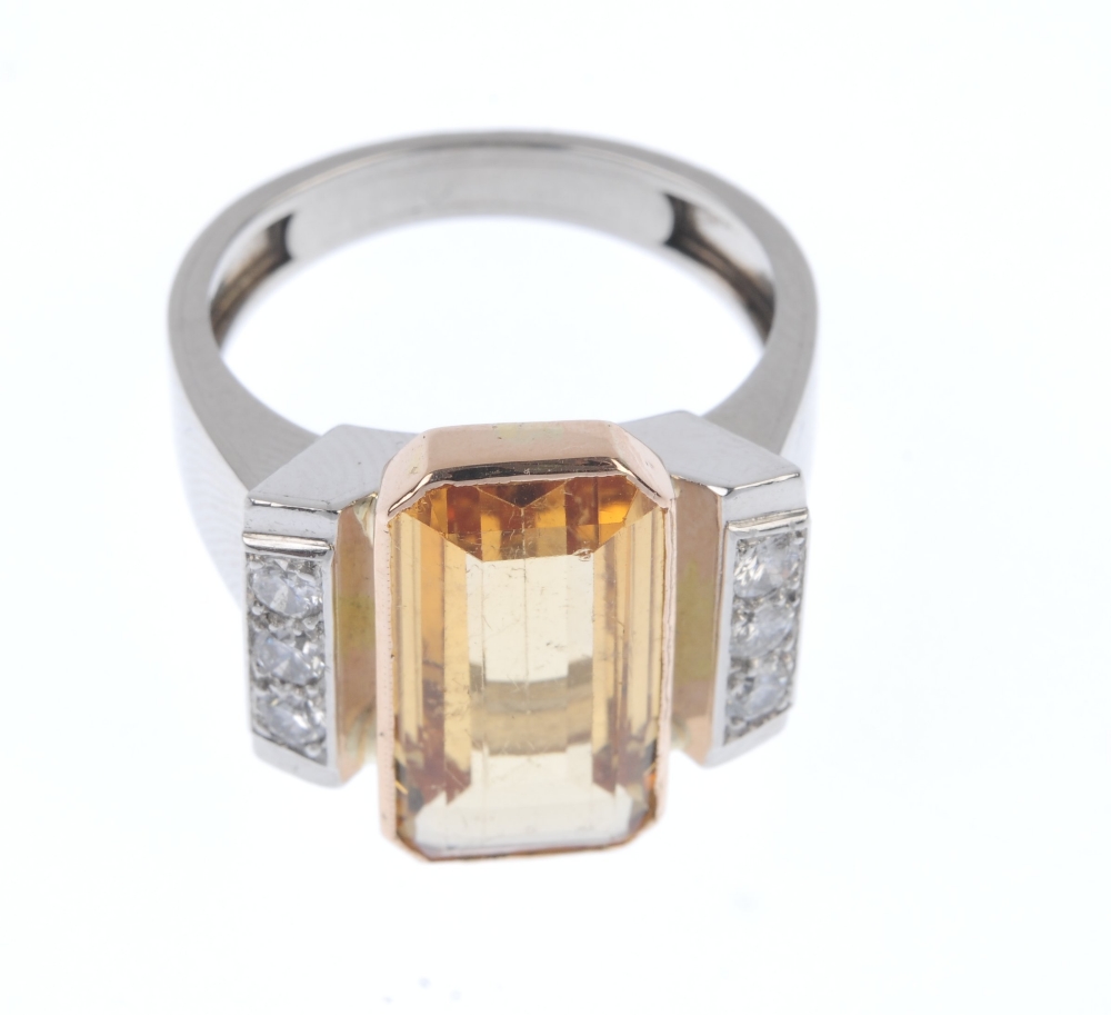 A topaz and diamond dress ring. The rectangular-shape golden topaz collet, to the brilliant-cut - Image 2 of 4