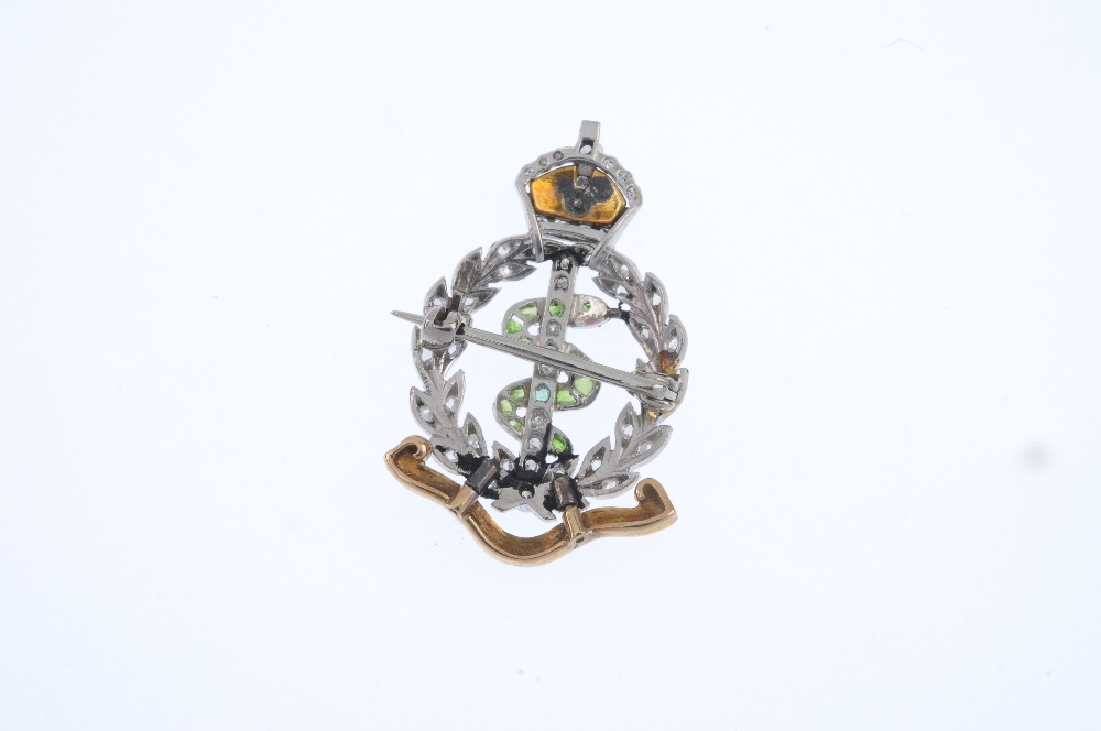 An early 20th century diamond, gem-set and enamel Royal Army Medical Corps brooch. The green gem and - Image 2 of 2