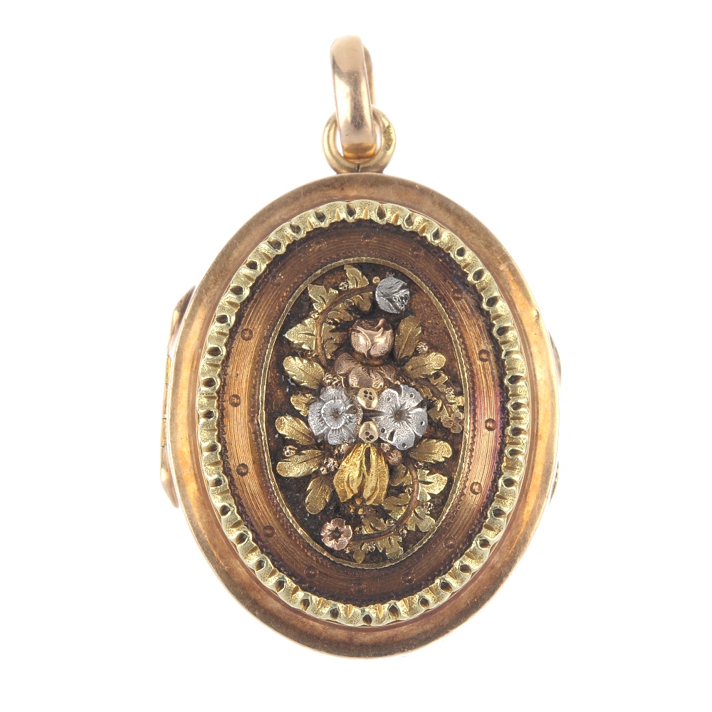 A mid 19th century 18ct gold floral locket. Of oval outline, the raised and chased tri-colour floral