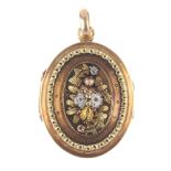 A mid 19th century 18ct gold floral locket. Of oval outline, the raised and chased tri-colour floral