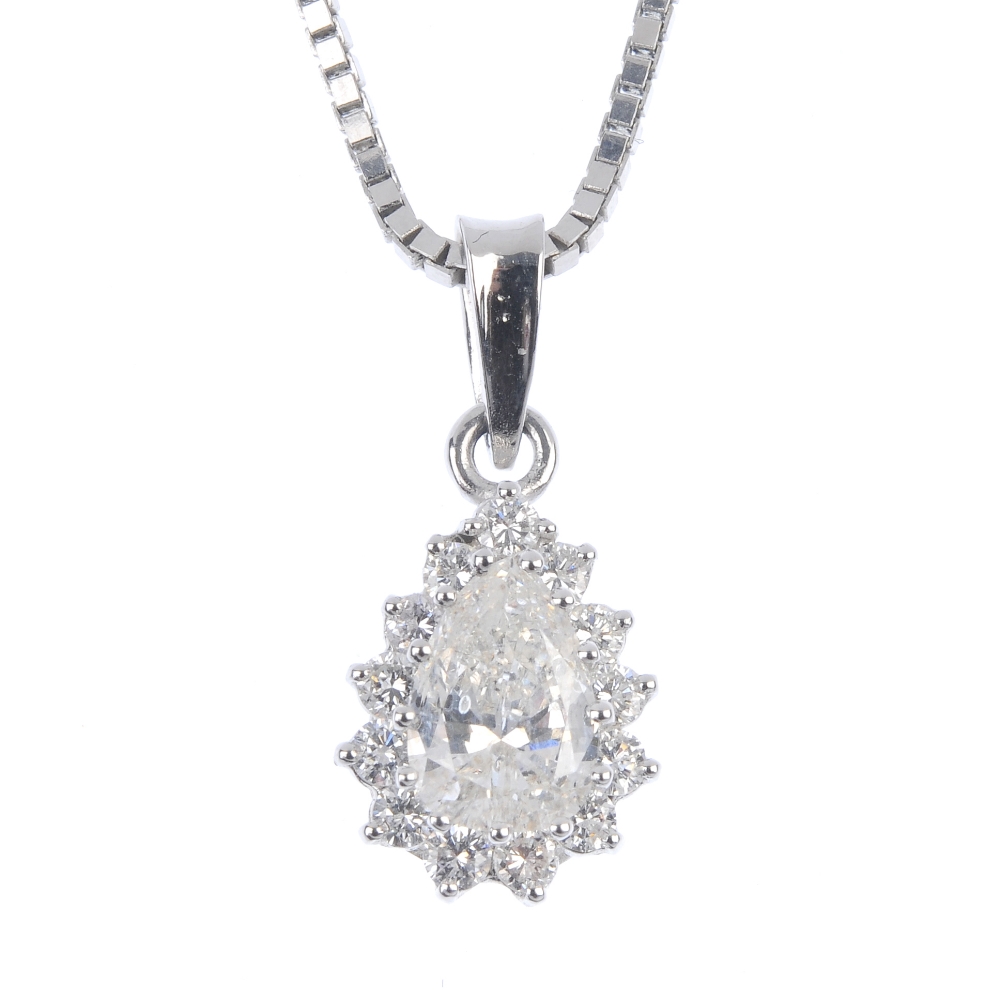 A diamond cluster pendant. The pear-shape diamond, within a brilliant-cut diamond surround,
