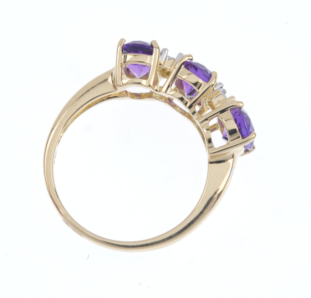 An 18ct gold amethyst and diamond ring. The oval-shape amethyst line, between single-cut diamond - Image 4 of 4