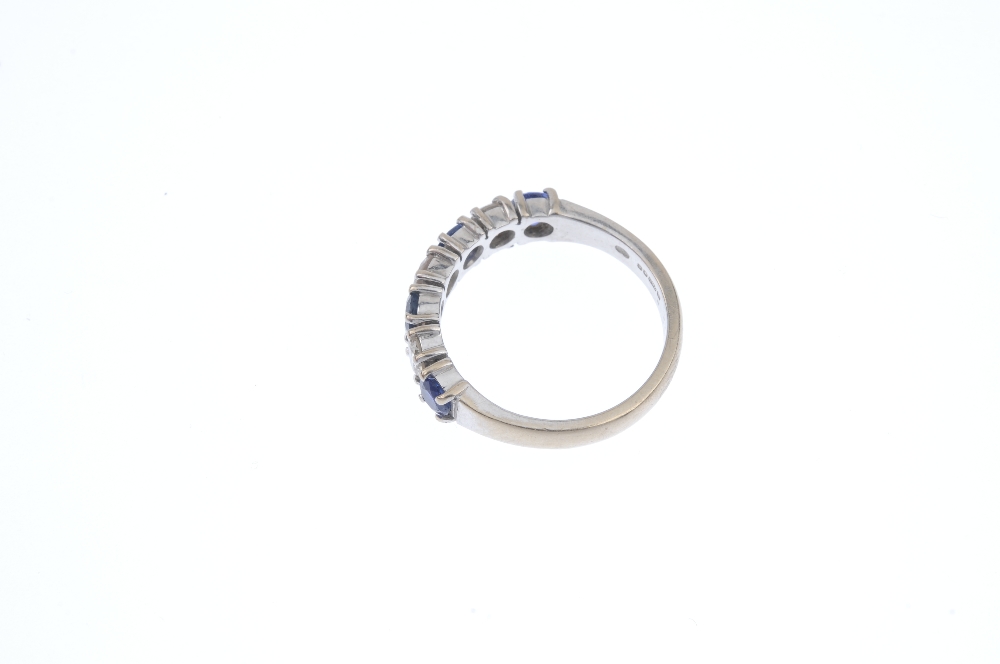 An 18ct gold sapphire and diamond band ring. The alternating brilliant-cut diamond and circular- - Image 3 of 4