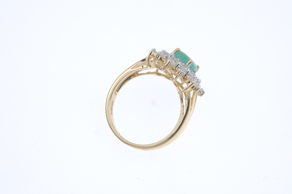 An 18ct gold emerald and diamond cluster ring. The oval-shape emerald, within a brilliant-cut - Image 4 of 4