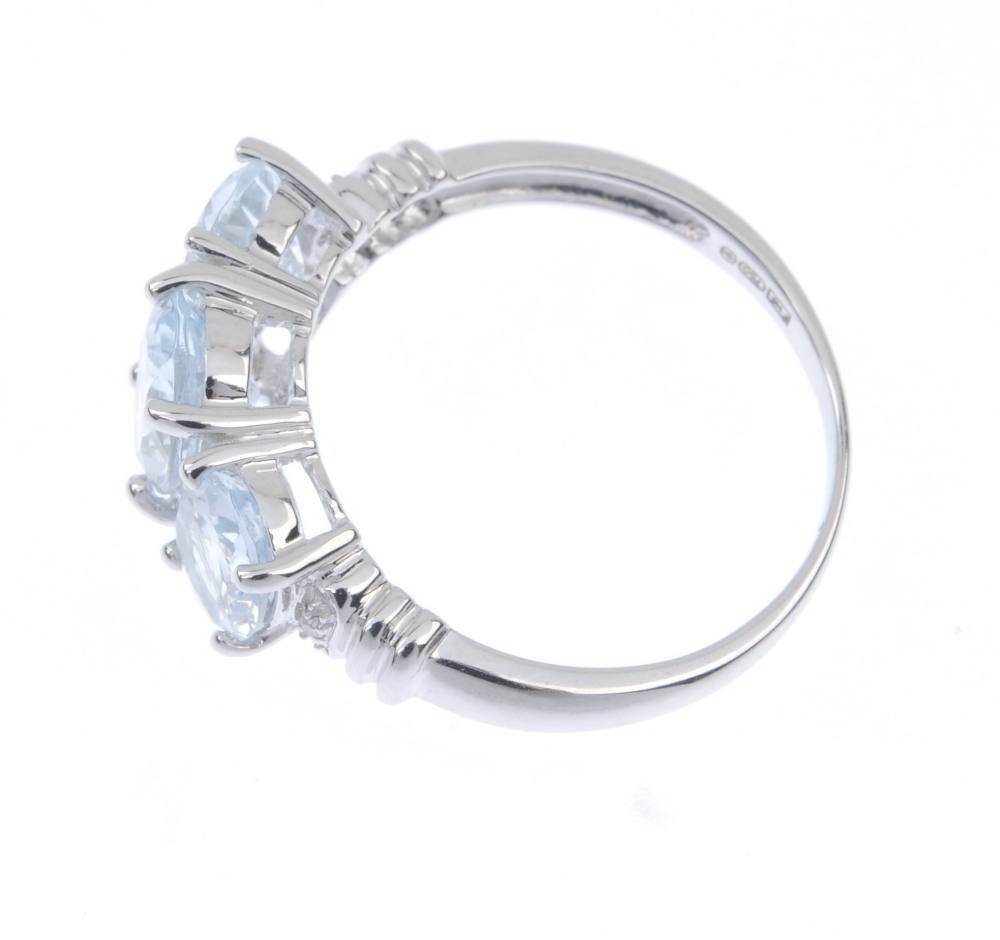 An 18ct gold aquamarine and diamond ring. The oval-shape aquamarine line, with single-cut diamond - Image 3 of 4