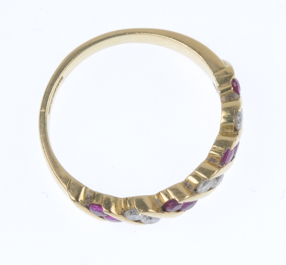 An 18ct gold ruby and diamond ring. Designed as a series of slanted circular-shape ruby pairs, - Image 3 of 4