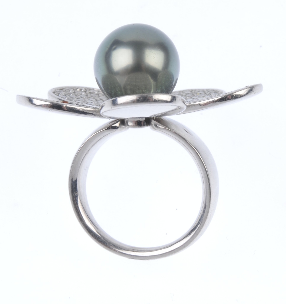 A cultured pearl and diamond flower ring. The grey cultured pearl, measuring 12.8mms, within a - Image 2 of 3