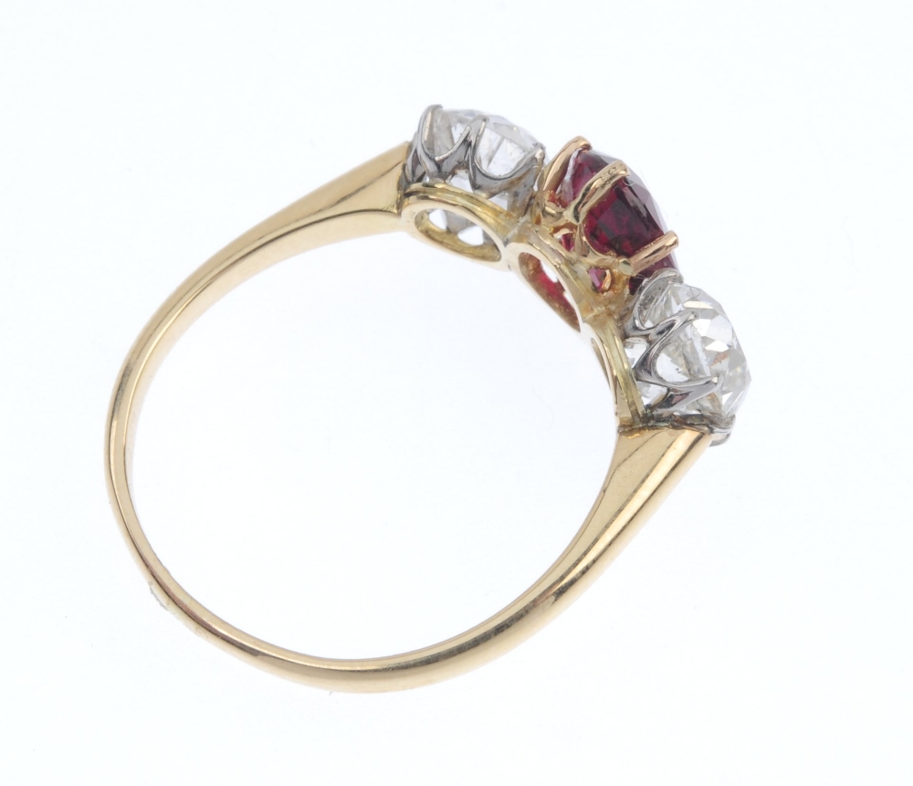 A diamond and ruby three-stone ring. The oval-shape ruby, with old-cut diamond sides, to the plain - Image 4 of 4