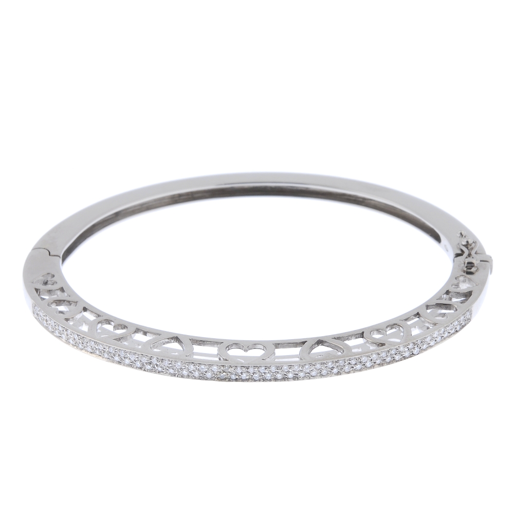 A diamond hinged bangle. The front designed as two brilliant-cut diamond lines, to the heart-shape