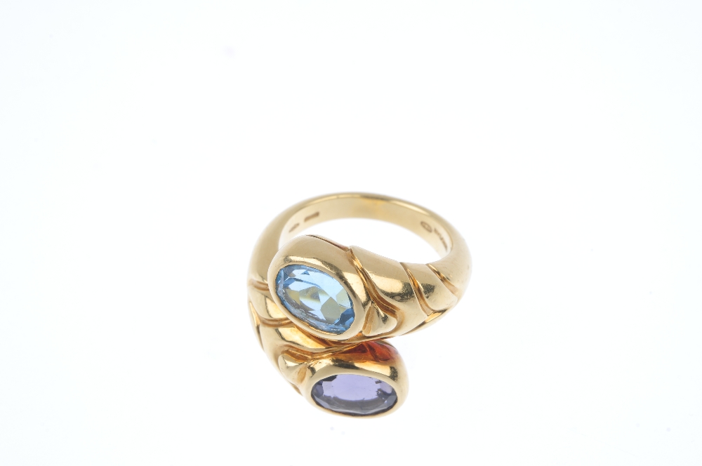 BULGARI - a gem-set crossover ring. Of asymmetric design, the grooved sides, with oval-shape blue - Image 2 of 4