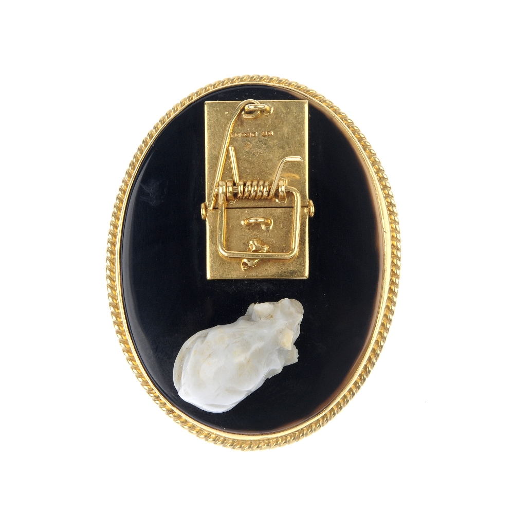 A 1970s 18ct gold and hardstone novelty panel. The oval-shape onyx base, with 18ct gold rope-twist