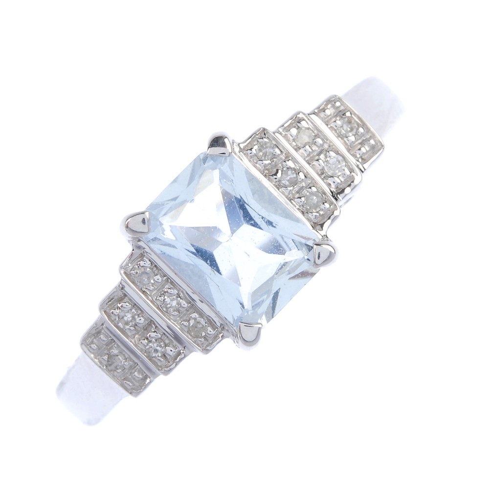 An 18ct gold aquamarine and diamond ring. The rectangular-shape aquamarine, to the single-cut