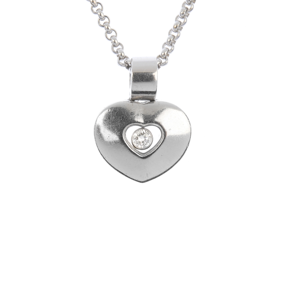 CHOPARD - a 'Happy Diamonds' heart pendant. The brilliant-cut diamond collet, suspended within a