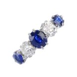 An early 20th century platinum and gold, sapphire and diamond ring. The alternating graduated oval-