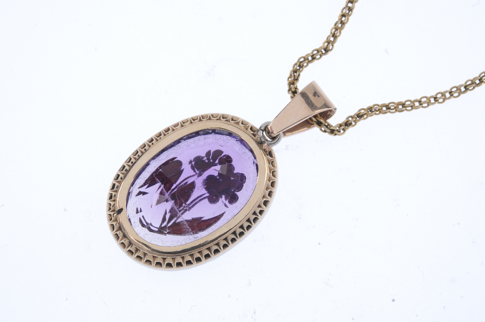 An early 20th century silver and gold, amethyst and diamond pendant. The oval-shape amethyst with - Image 3 of 4