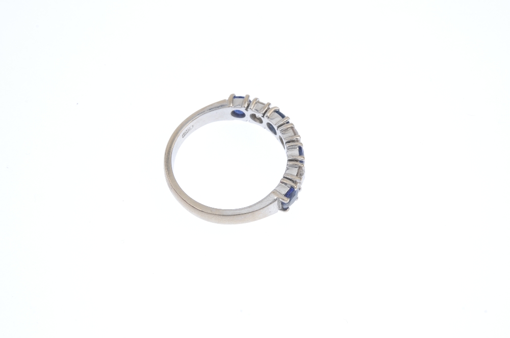 An 18ct gold sapphire and diamond band ring. The alternating brilliant-cut diamond and circular- - Image 4 of 4