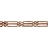 An early 20th century 9ct gold bracelet. Designed as a series of alternating gate and brick-links,