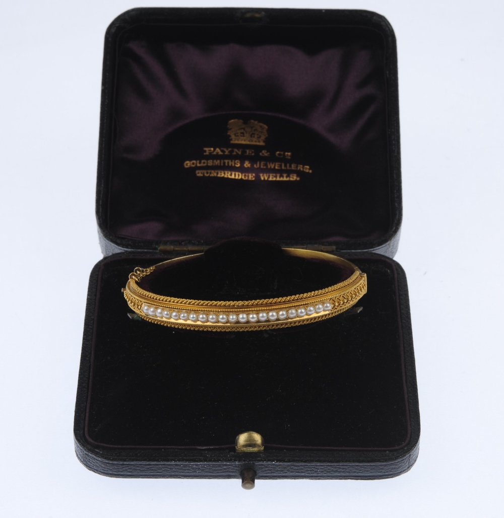 A late 19th century gold split pearl hinged bangle. The split pearl line, to the bead accent sides - Image 4 of 4