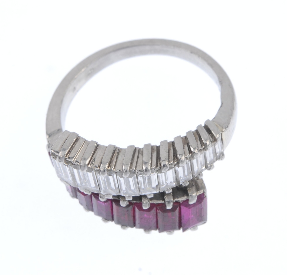 A mid 20th century Burmese ruby and diamond crossover ring. Comprising two graduated baguette-cut - Image 2 of 5