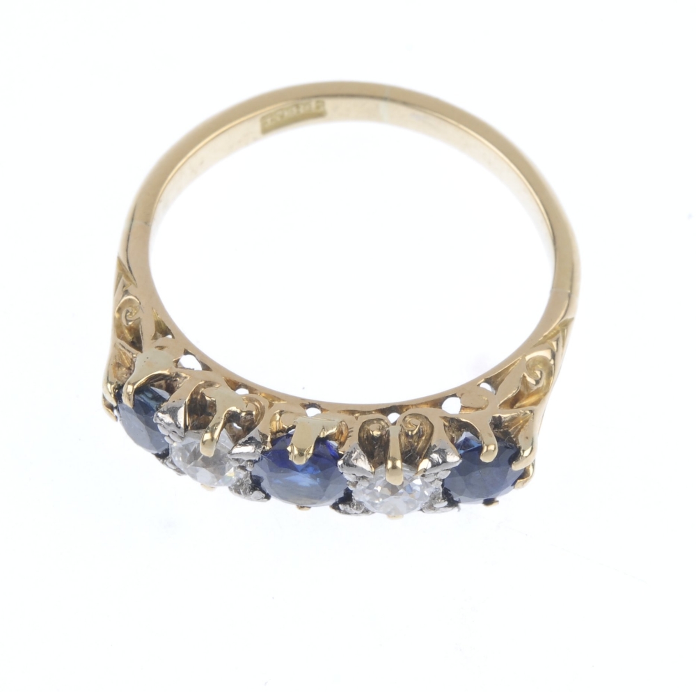 A sapphire and diamond ring. The graduated oval-shape sapphire line, with old-cut diamond spacers, - Image 2 of 4