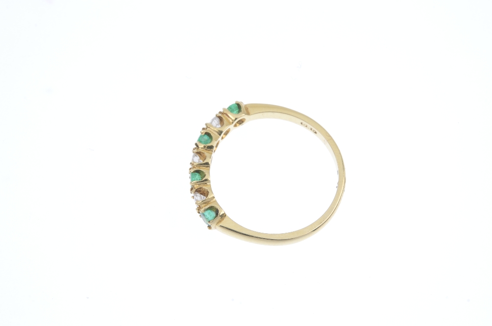 An 18ct gold emerald and diamond seven-stone ring. The alternating brilliant-cut diamond and - Image 3 of 4