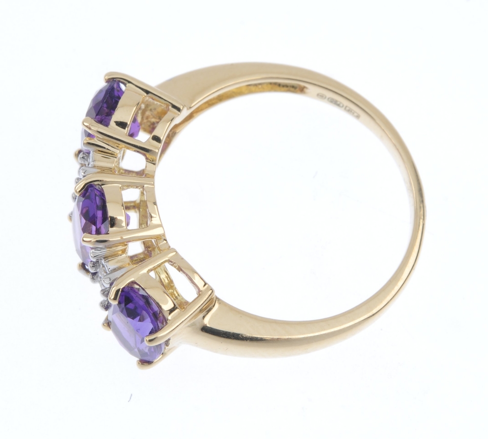 An 18ct gold amethyst and diamond ring. The oval-shape amethyst line, between single-cut diamond - Image 3 of 4