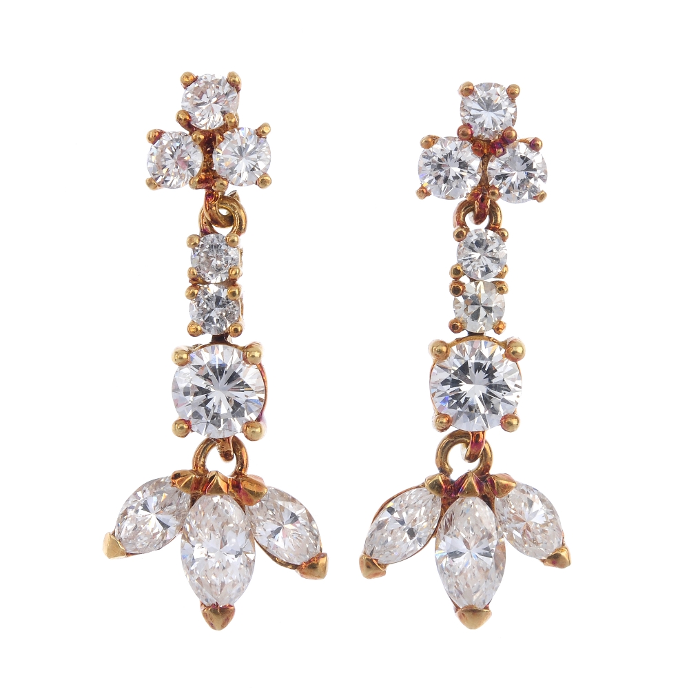 A pair of diamond ear pendants. Each of articulated design, the marquise-shape diamond trio,