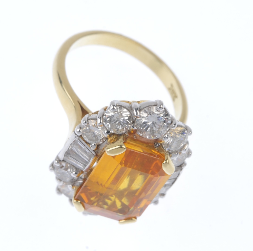 An 18ct gold sapphire and diamond cluster ring. The rectangular-shape orange sapphire, within a - Image 2 of 4