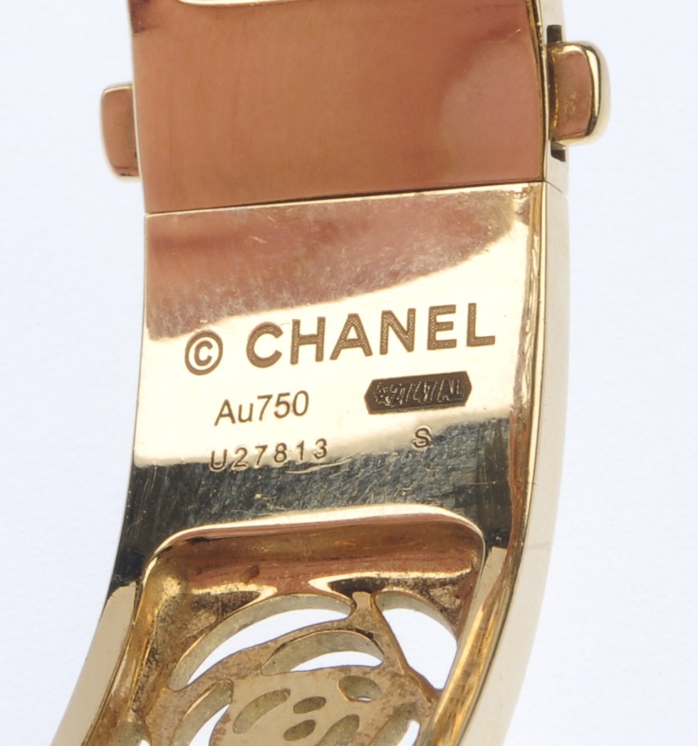 CHANEL - a 'Camelia' bangle. The hinged sides, each with pierced rose frieze. Signed and numbered - Image 2 of 3